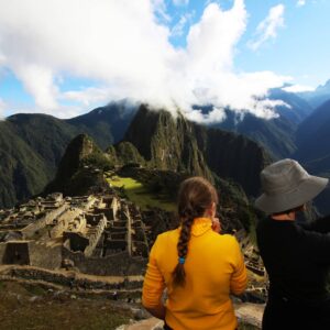 A couple stares at Machu Picchu's citadel from the Guardian's house.